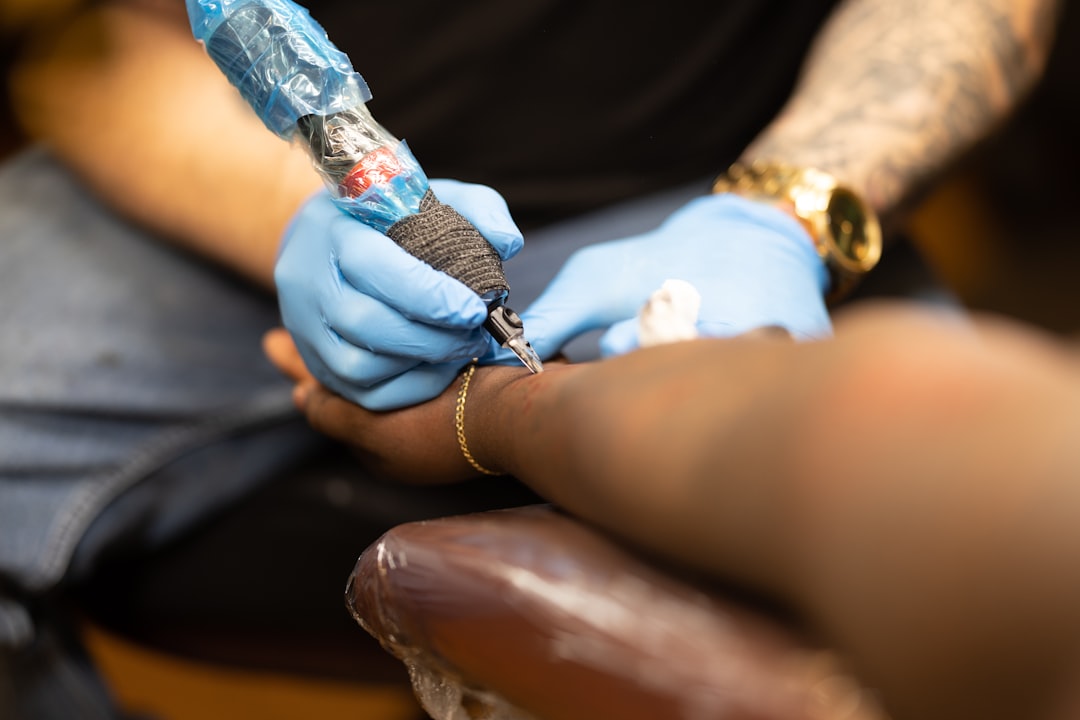A client receives a tattoo on their wrist.